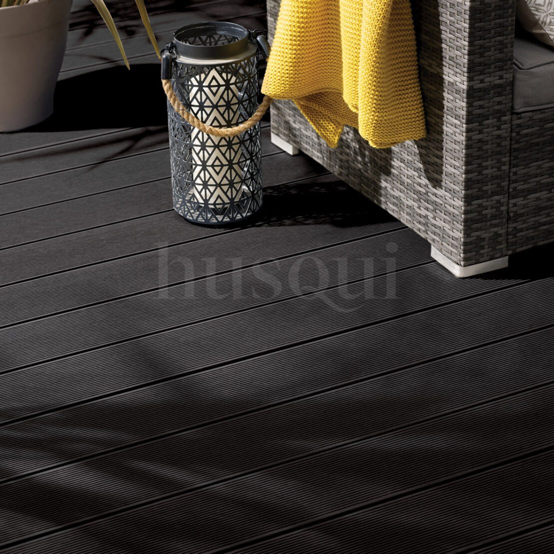 Black composite decking courtyard with a corner sofa and lantern