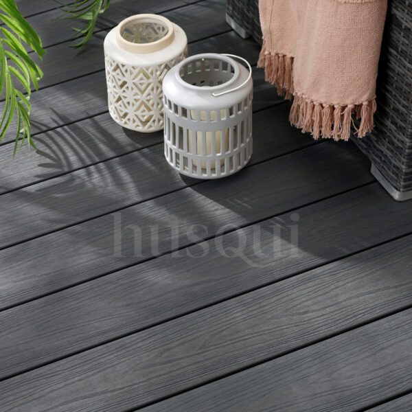 Grey wood grain decking with corner sofa and two lanterns