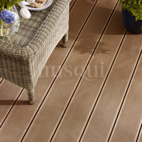 Teak lined composite decking with wicker chair and flowers