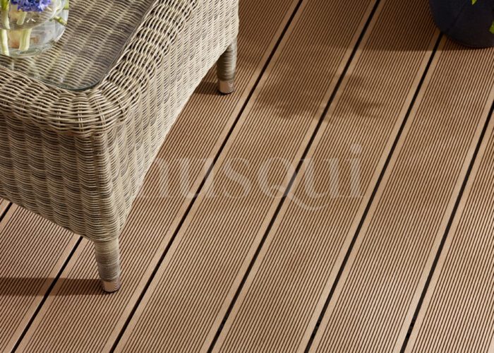 Teak lined composite decking with wicker chair and flowers