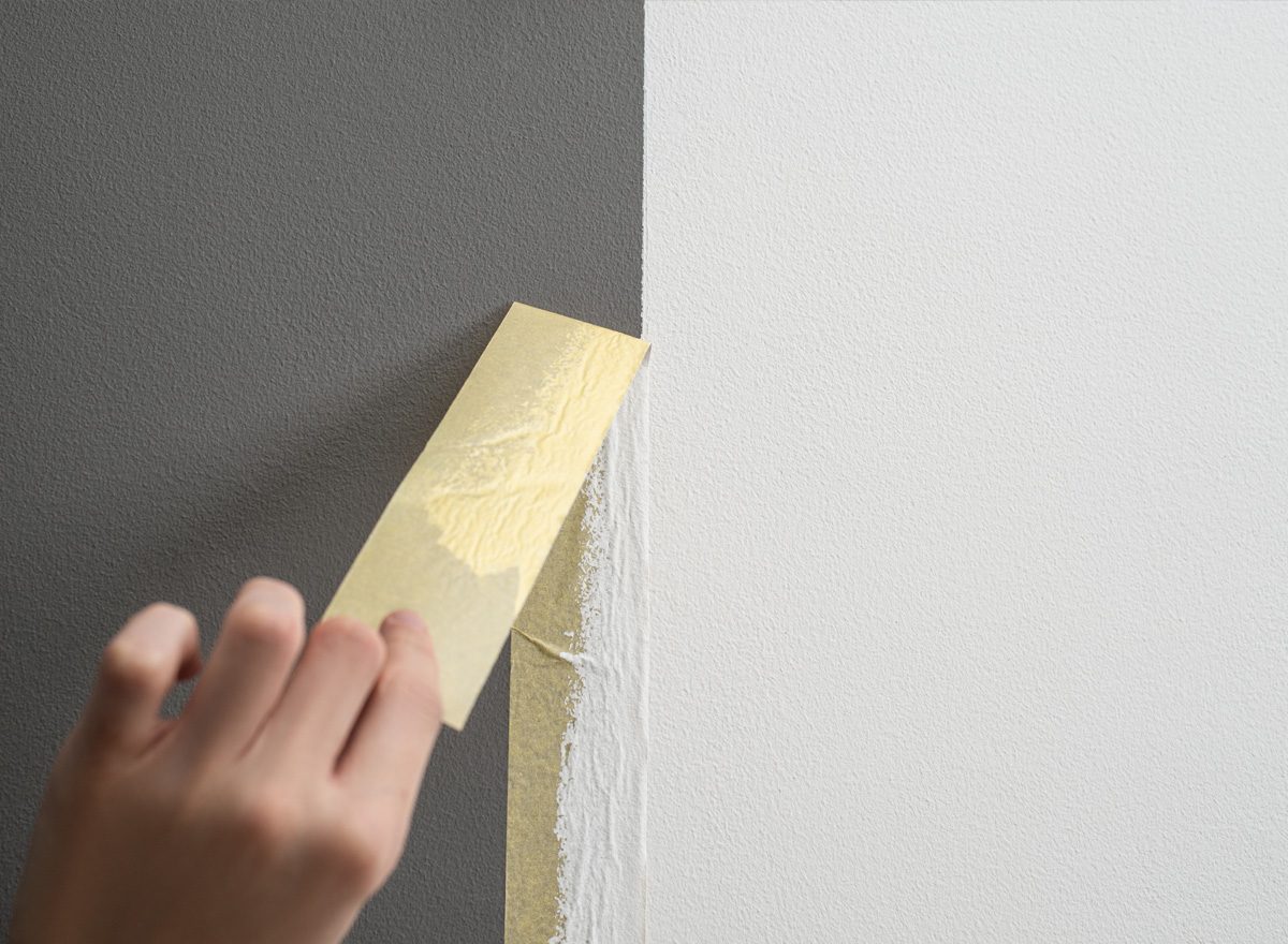 Husqui DIY category image of masking tape being pulled off painted wall